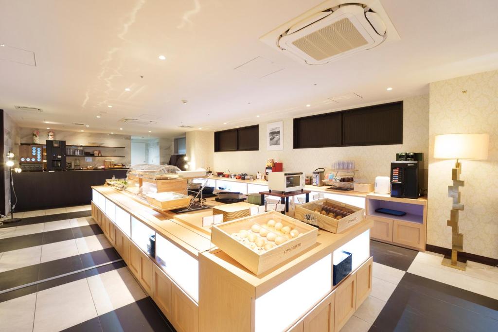 a kitchen with a counter with boxes on it at Centurion Hotel Grand Kobe Station in Kobe