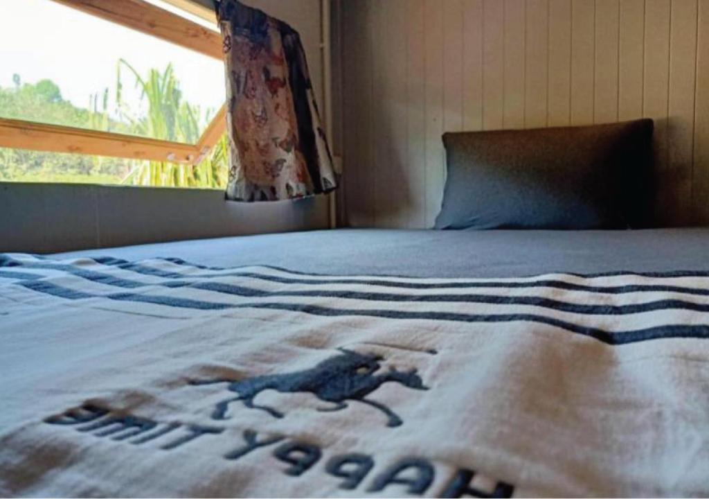 a bed with a blanket with a monkey on it at Farm House kohyaoyai in Ko Yao Yai