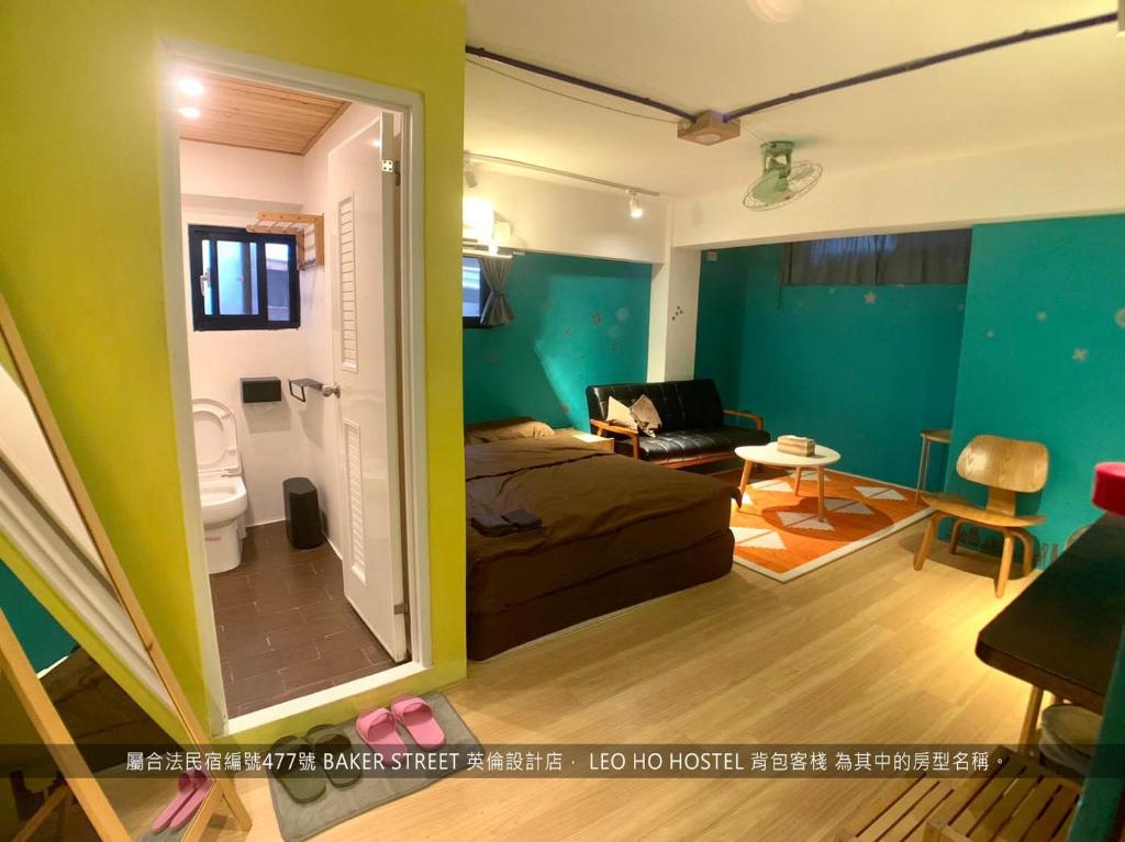 a bedroom with a bed and a room with a bathroom at Leo Ho Hostel in Tainan