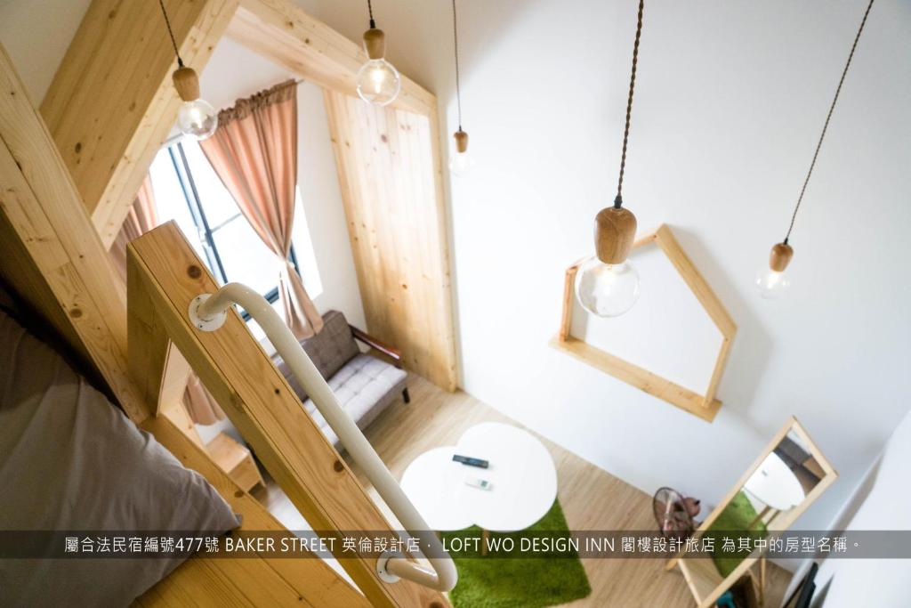 a room with a staircase with a table and a window at Loft Wo Design Inn in Tainan