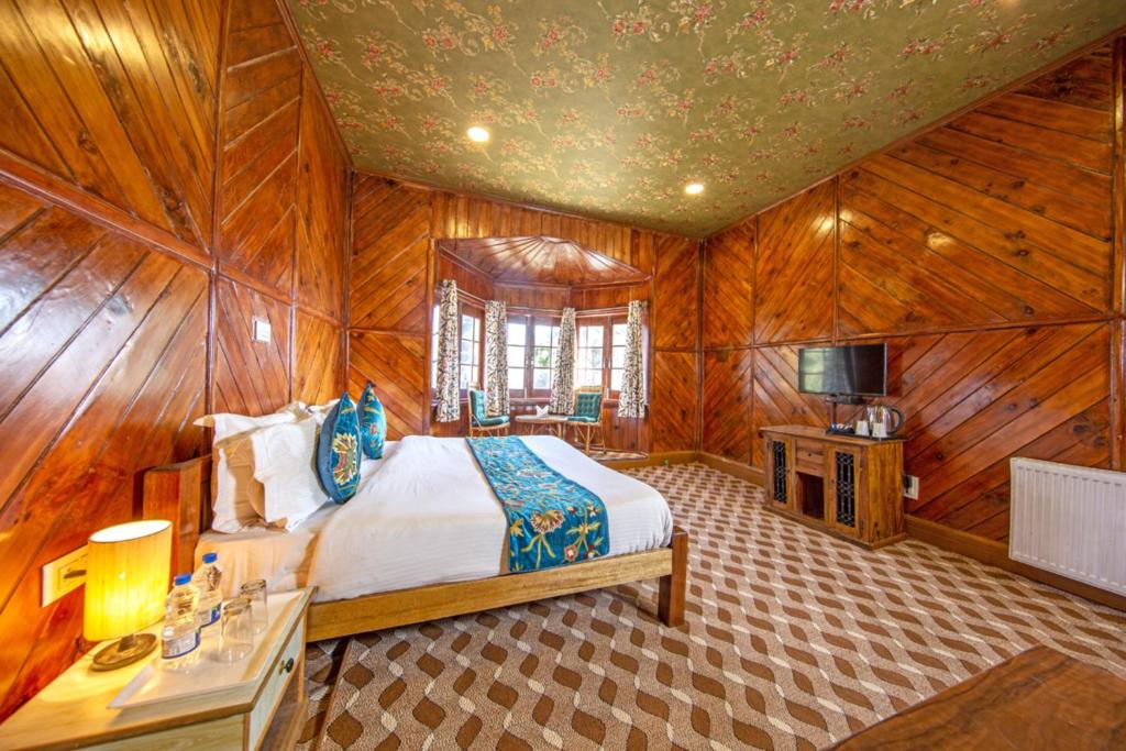 a bedroom with a bed in a wooden room at Gulmarg Ski Hill Resort in Gulmarg