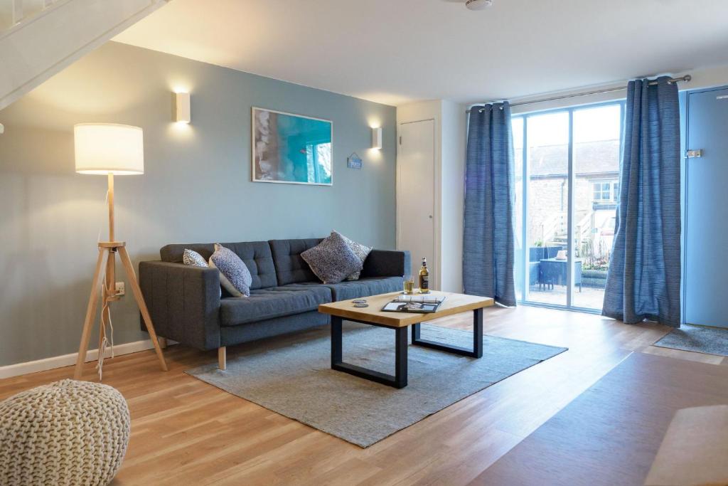 a living room with a couch and a table at Coverack in Budock Water