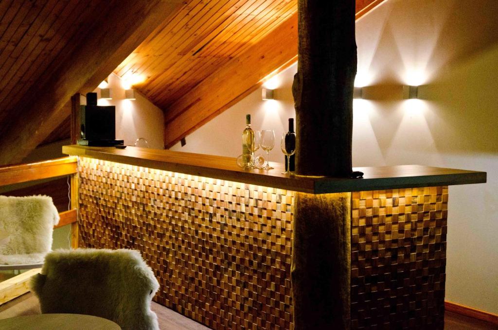 a room with a brick fireplace with two chairs at Hotel Robledal in Las Trancas