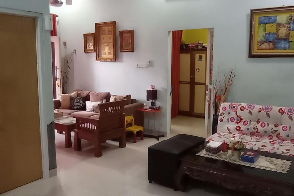 a living room with a couch and a chair and a table at Cheerfull residential home - Dillair Home Stay in Talang Kelapa