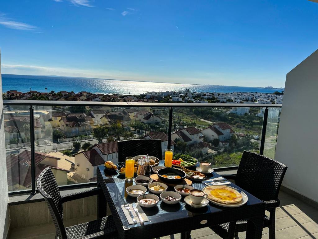 a table with food on it with a view of the ocean at Sophia Pool Apartments in Caesar Blue Resort including Breakfast till 4pm, Gym, 5 Swimming Pools, Sauna, Hammam, Kids' club available in Perivolia tou Trikomou