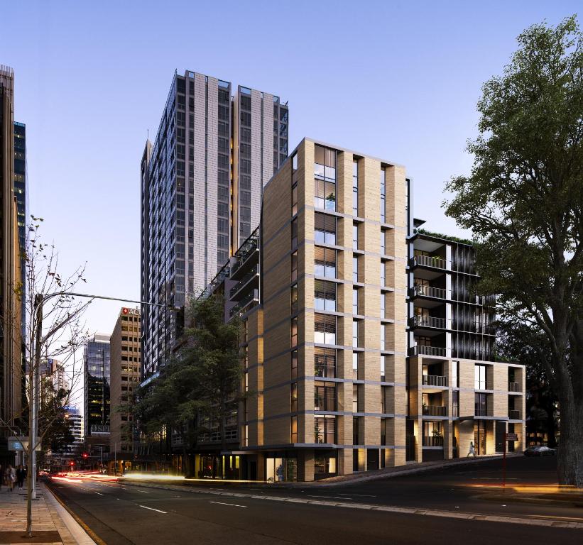 een hoog gebouw in een stadsstraat met gebouwen bij Urban Rest North Sydney Apartments in Sydney