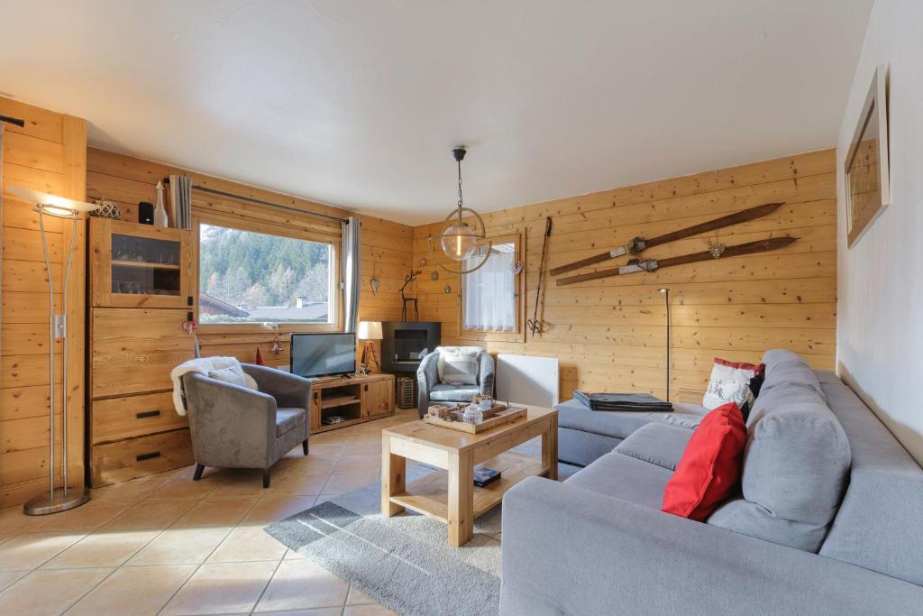 a living room with a couch and chairs and a tv at Appt Bec A2 - Happy Rentals in Le Tour