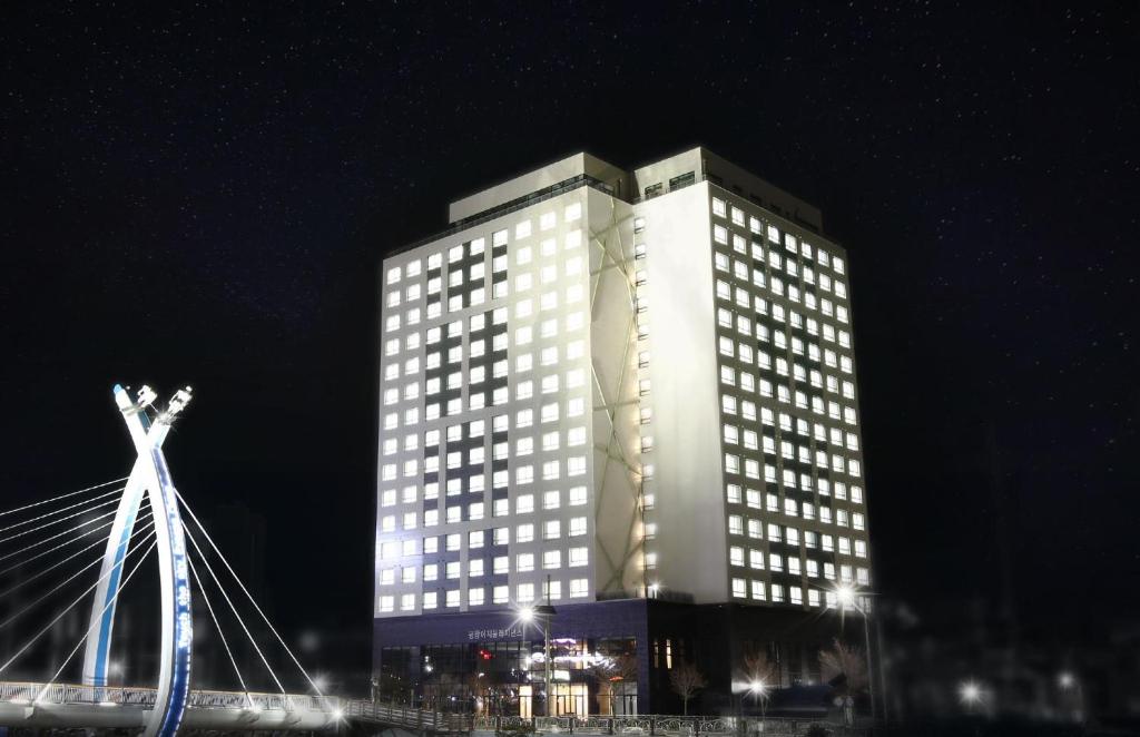 a tall building with lit up windows at night at AM Hotel in Pyeongchang