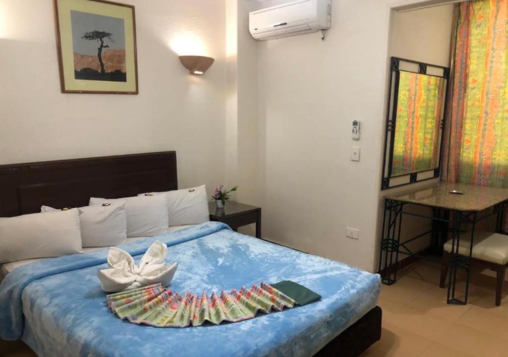 Postel nebo postele na pokoji v ubytování Bonne Vie Hotel