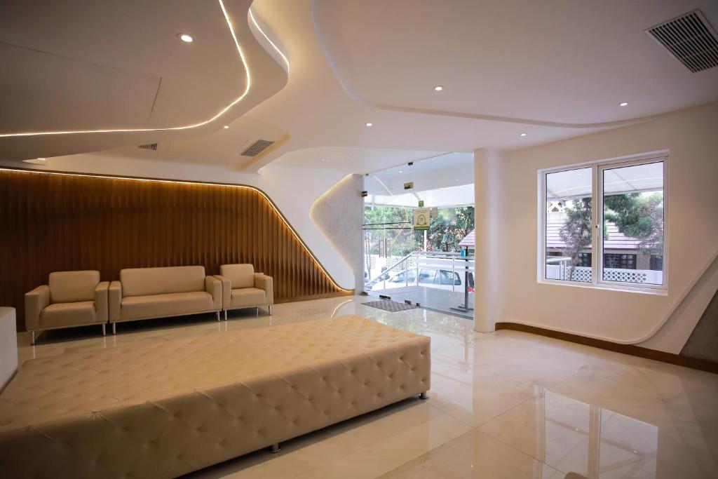 una sala de estar con un sofá grande en el centro en Millennium Continental, en Kochi