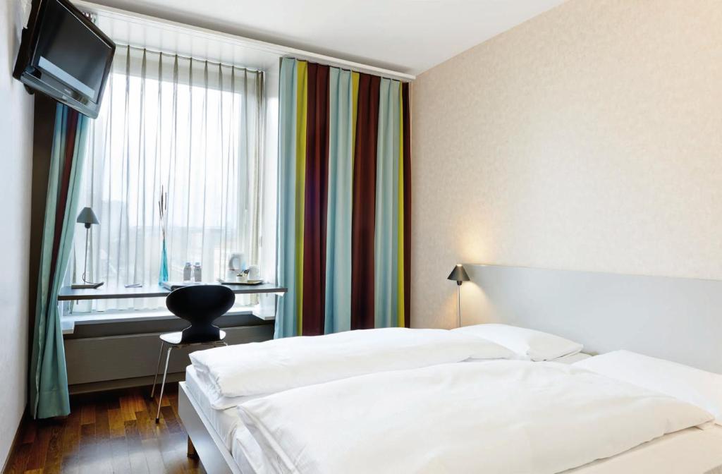 Postel nebo postele na pokoji v ubytování Sorell Hotel Ador