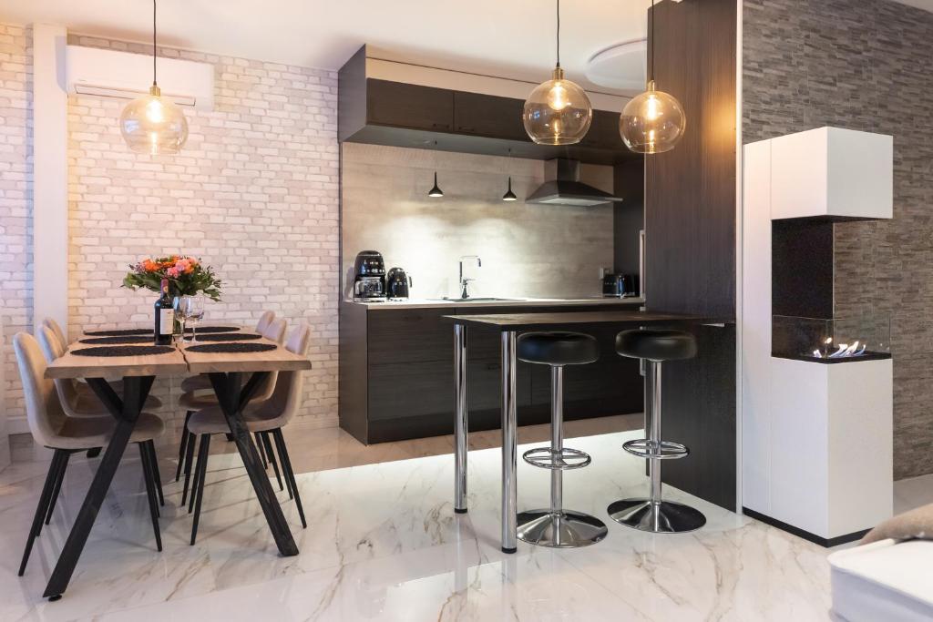 a kitchen with a table and chairs and a counter at City Garden Apartments 2 in Rovaniemi