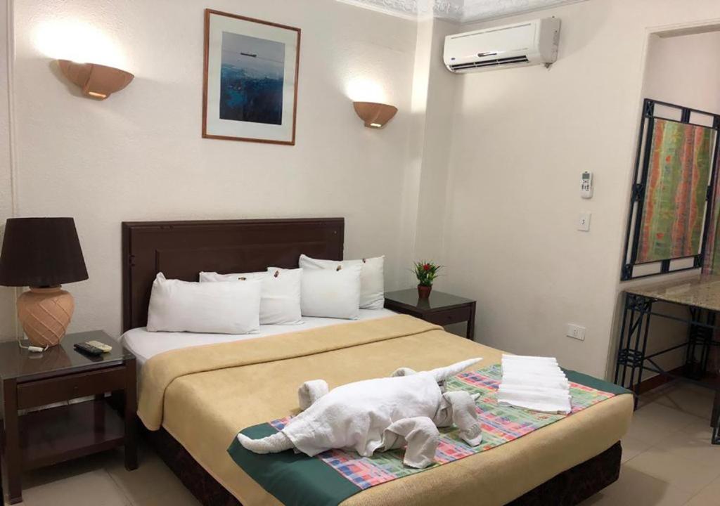 Postel nebo postele na pokoji v ubytování Bonne Vie Hotel