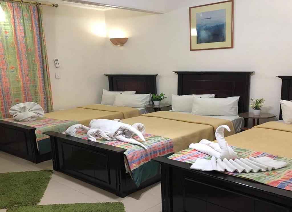 Postel nebo postele na pokoji v ubytování Bonne Vie Hotel