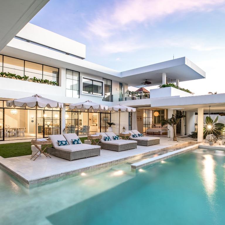 an exterior view of a house with a swimming pool at Umbala the house in Canggu