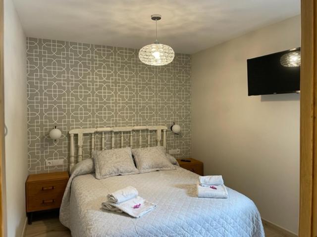 Postel nebo postele na pokoji v ubytování Apartamentos Casa Isabale