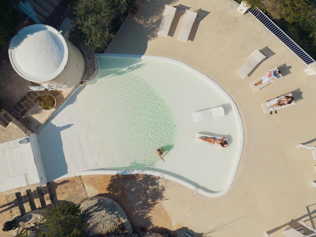 widok na basen z osobami na plaży w obiekcie Corte Di Ferro Hotel & Wellness Resort w mieście Carovigno