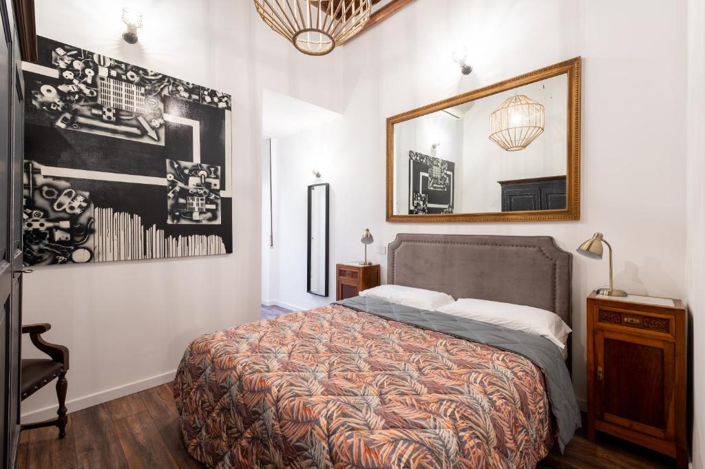 a bedroom with a bed and a mirror on the wall at Appartamento trastevere Roma in Rome