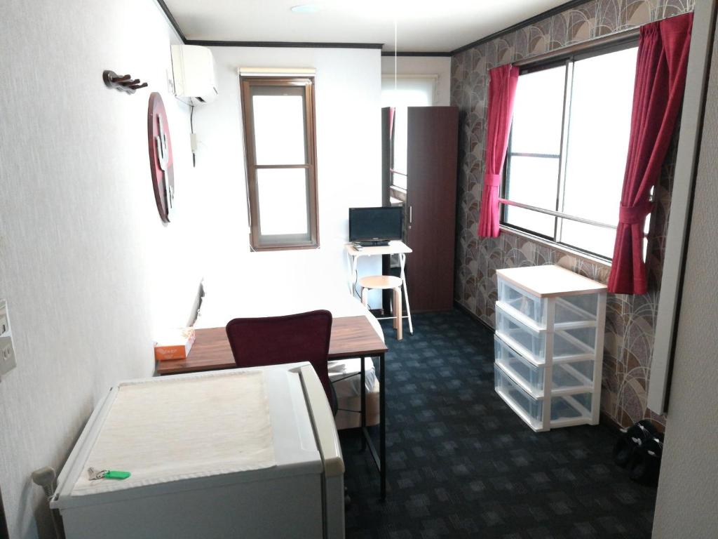 a room with a desk and a table and a window at COTE sakuragawa "Room 201,301,401" - Vacation STAY 03134v in Osaka
