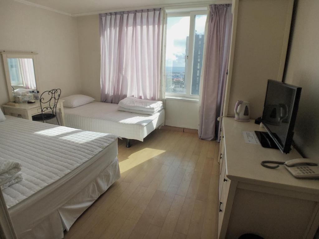 Postel nebo postele na pokoji v ubytování Hotel Good Inn