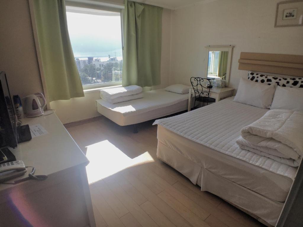 Postel nebo postele na pokoji v ubytování Hotel Good Inn