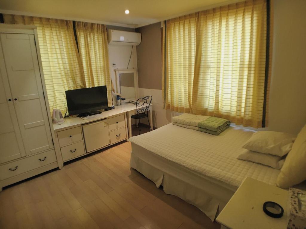 Postel nebo postele na pokoji v ubytování Hotel Good Inn