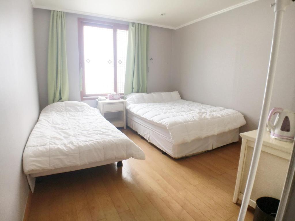 Postel nebo postele na pokoji v ubytování Hotel Good Inn