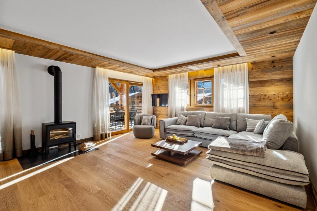 a living room with a couch and a fireplace at Chalet Larchwood by Mrs Miggins in Grimentz