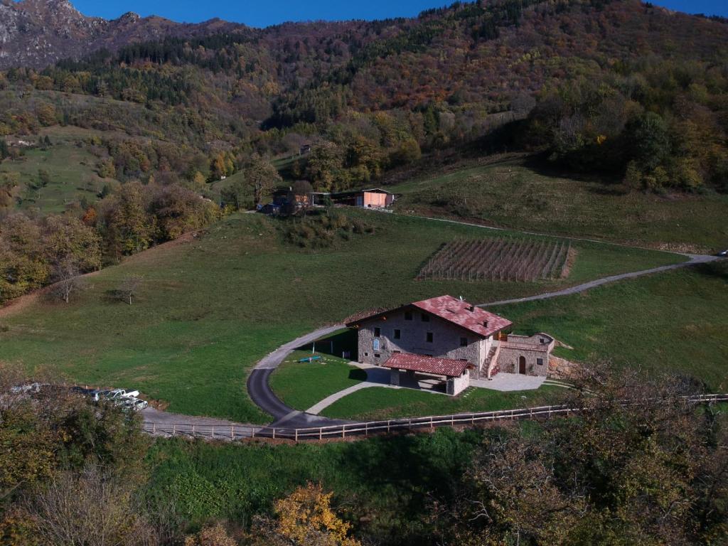 an old house on a hill in a field at Agriturismo Piane in Ono Degno