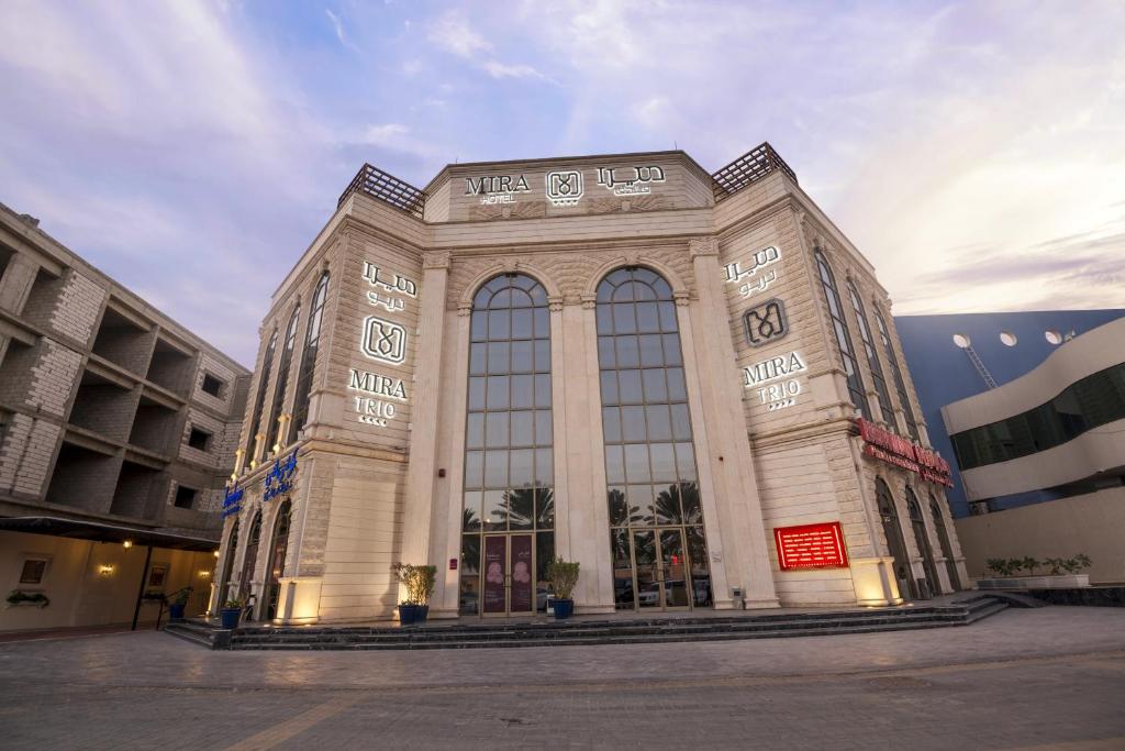 a large building with large windows in a city at Mira Trio Hotel - Riyadh - Tahlia Street in Riyadh