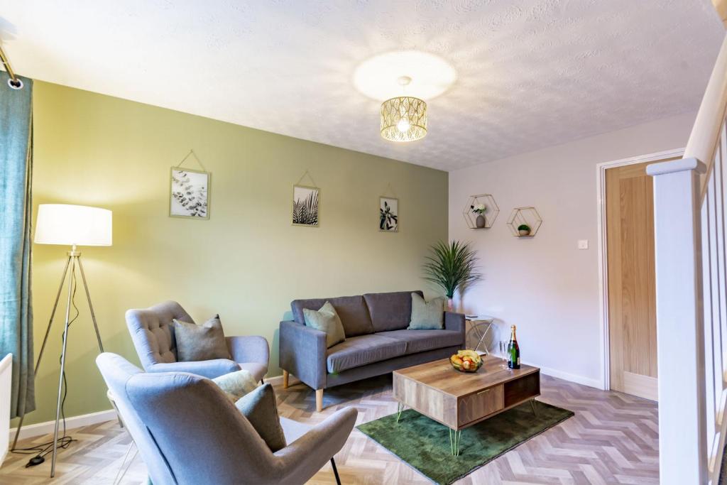a living room with two couches and a coffee table at K Suites - Goldcrest Road in Nottingham