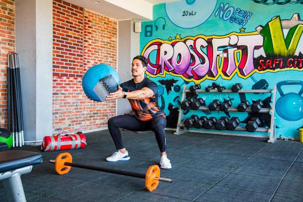 a man sitting on a scooter in a gym at Valley Boutique Hotel in Safi