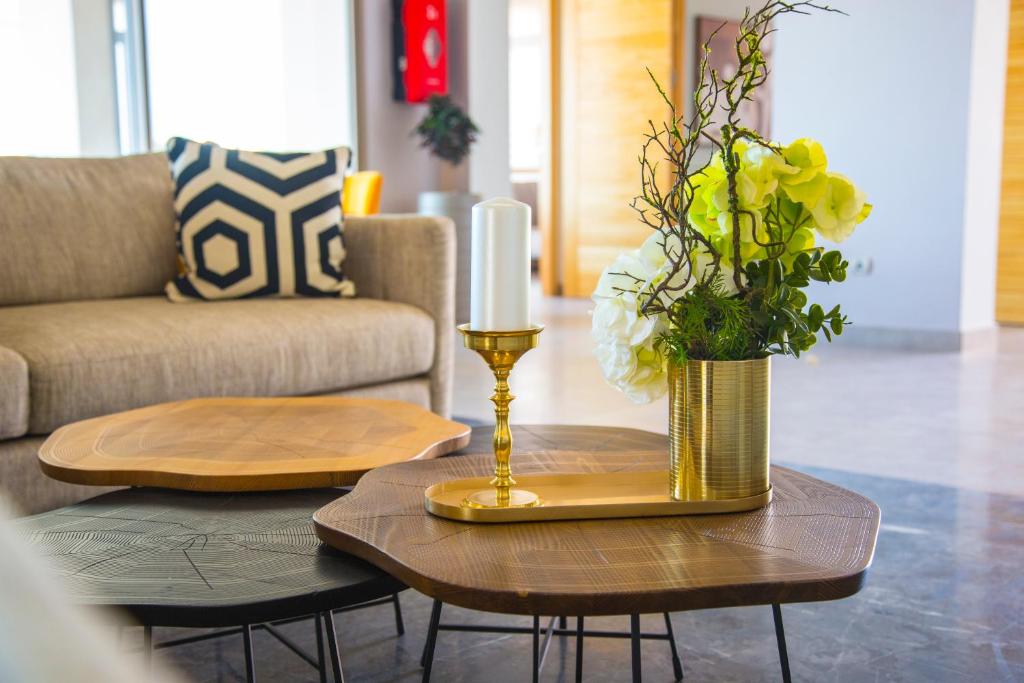 a table with a candle and a vase with flowers on it at Valley Boutique Hotel in Safi