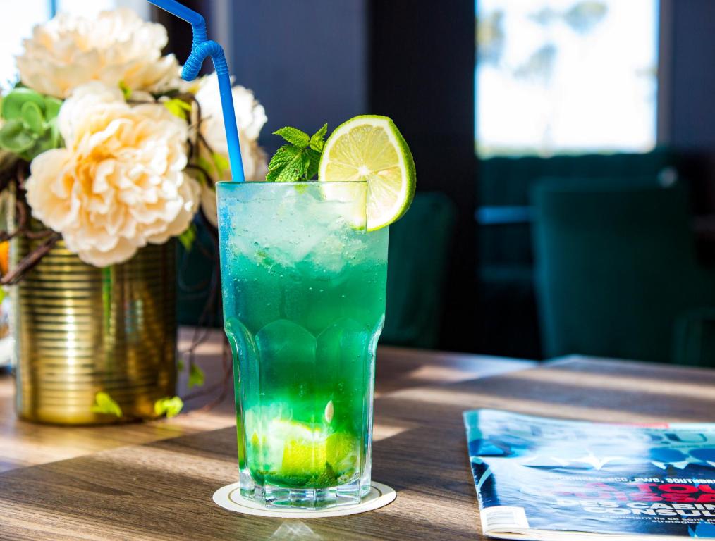 a drink sitting on a table with a slice of lime at Valley Boutique Hotel in Safi