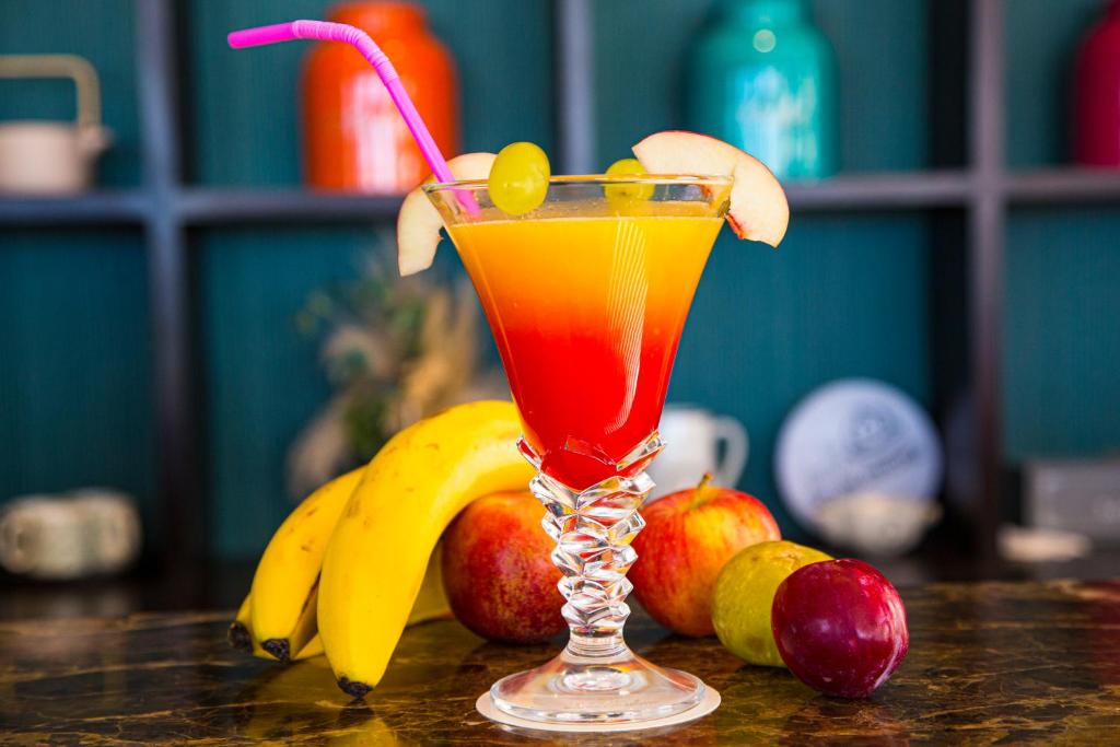 a drink in a glass sitting on a table with fruit at Valley Boutique Hotel in Safi