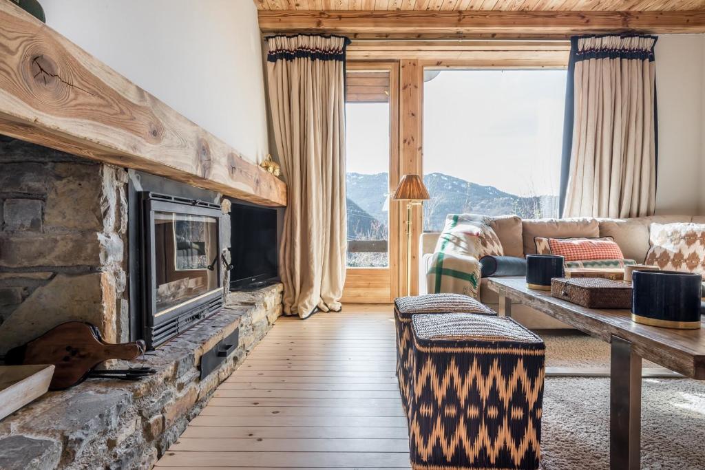 a living room with a couch and a fireplace at Casa Bosque by Totiaran in Naut Aran