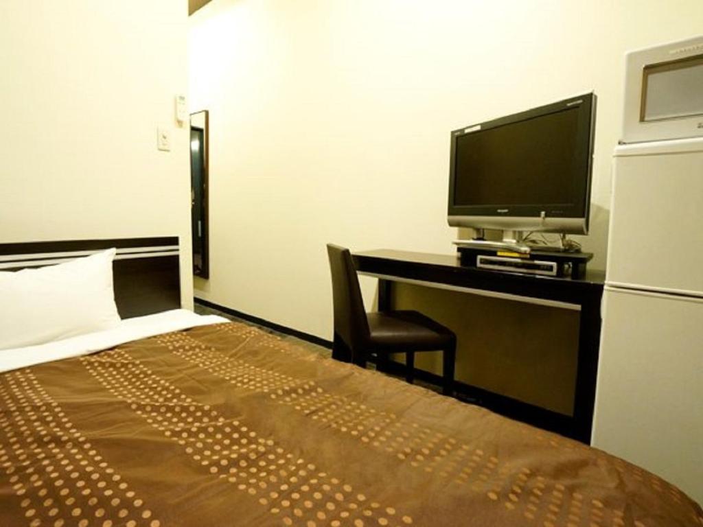 Postel nebo postele na pokoji v ubytování HOTEL LiVEMAX BUDGET Esaka