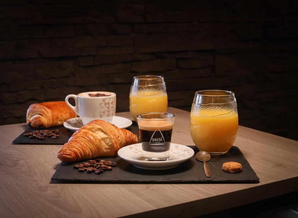 a tray with two glasses of orange juice and croissants at Hostellerie LE PANEL in Mandelieu-La Napoule
