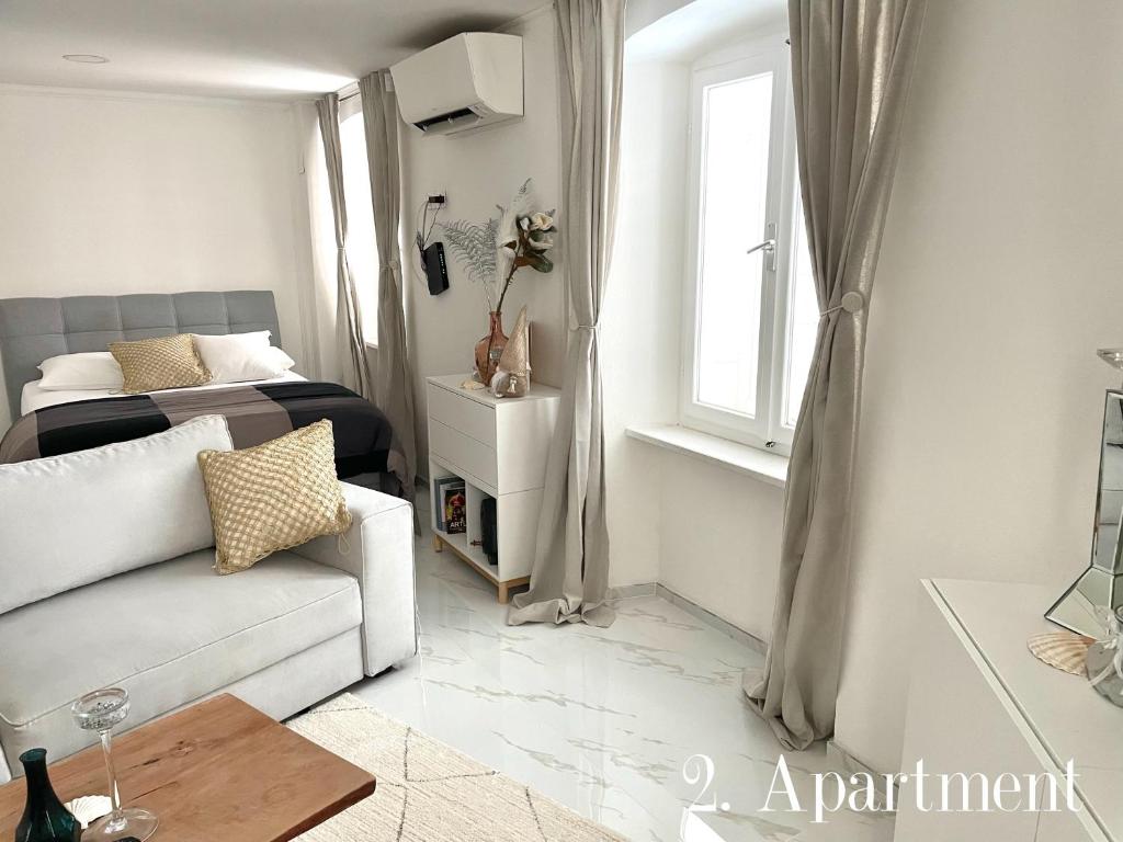 a living room with a couch and a bed at ApartHouse Porto in Piran