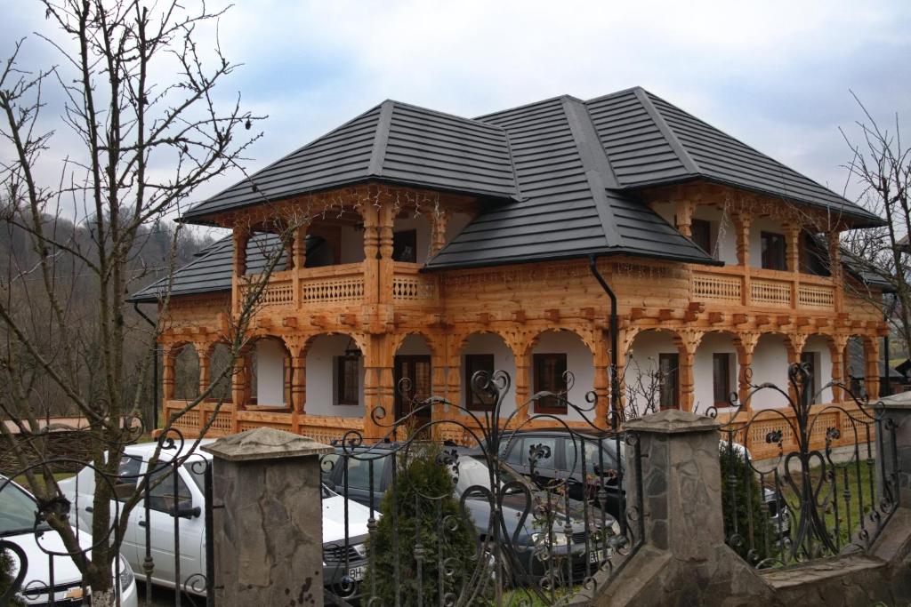 a large wooden house with a black roof at Casa Traditionala Breb in Breb