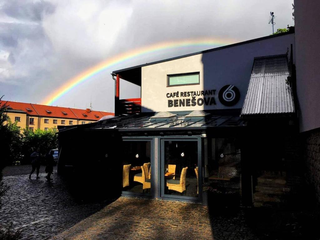 a rainbow in the sky behind a building at Hotel Apartments Benešova 6 in Kutná Hora