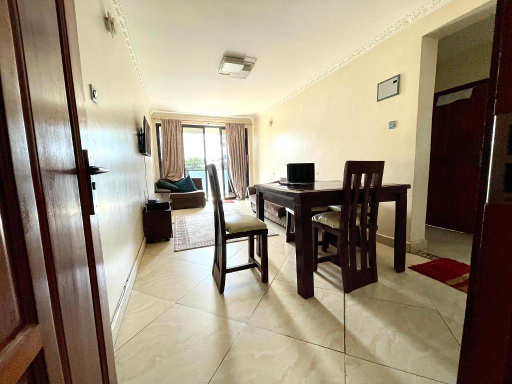 a dining room with a table and two chairs at 2Bedroom City Apartment with WiFi & Washing Machine. 5min Walk to CBD in Kampala