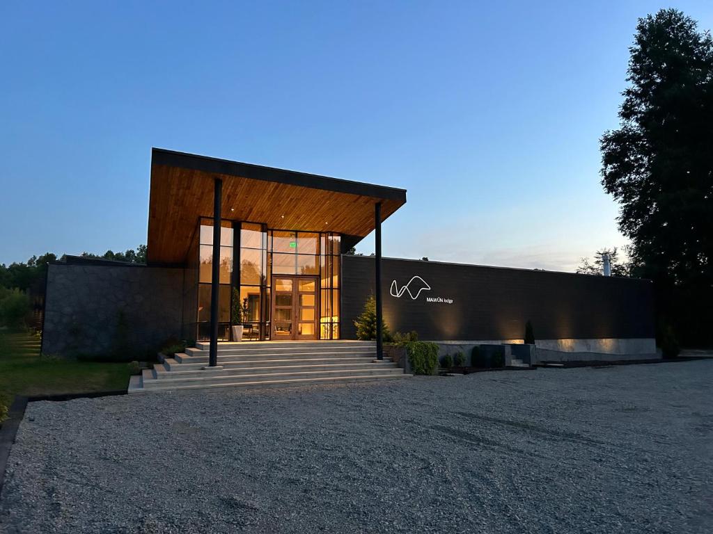 uma casa moderna com portas de vidro e um edifício em Mawün Lodge em Villarrica