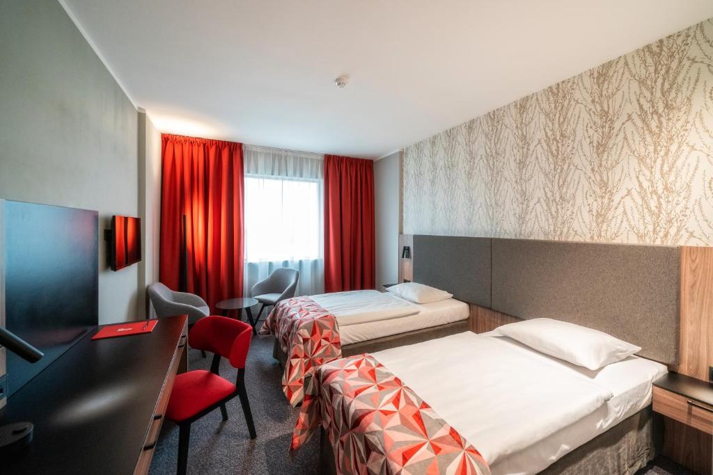 Posteľ alebo postele v izbe v ubytovaní HP Park Plaza