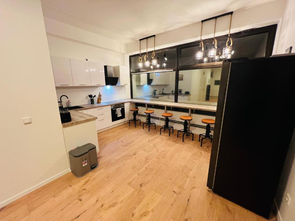 a kitchen with a bar with stools in it at Big Apartment l 18 Beds l Free Parking l WiFi l in Erwitte