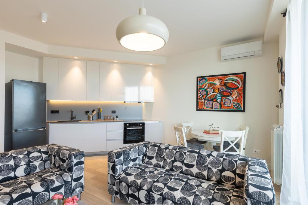 a living room with a couch and a kitchen at Belgrade Waterfront Lux 2 in Belgrade