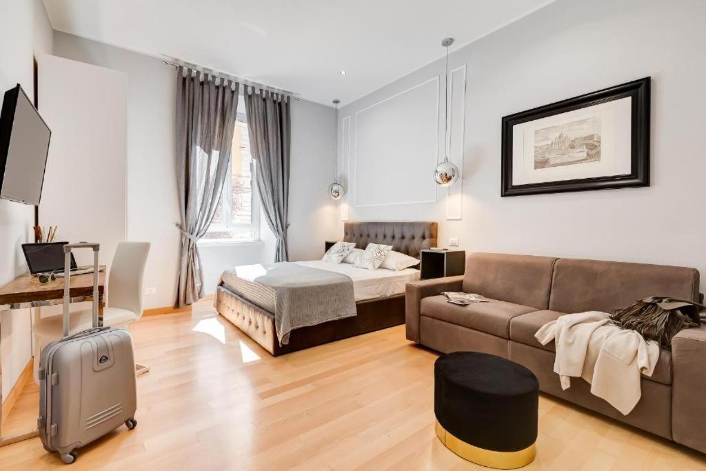 a living room with a couch and a bed at Vatican Prestige Apt by Premium Suites Collection in Rome
