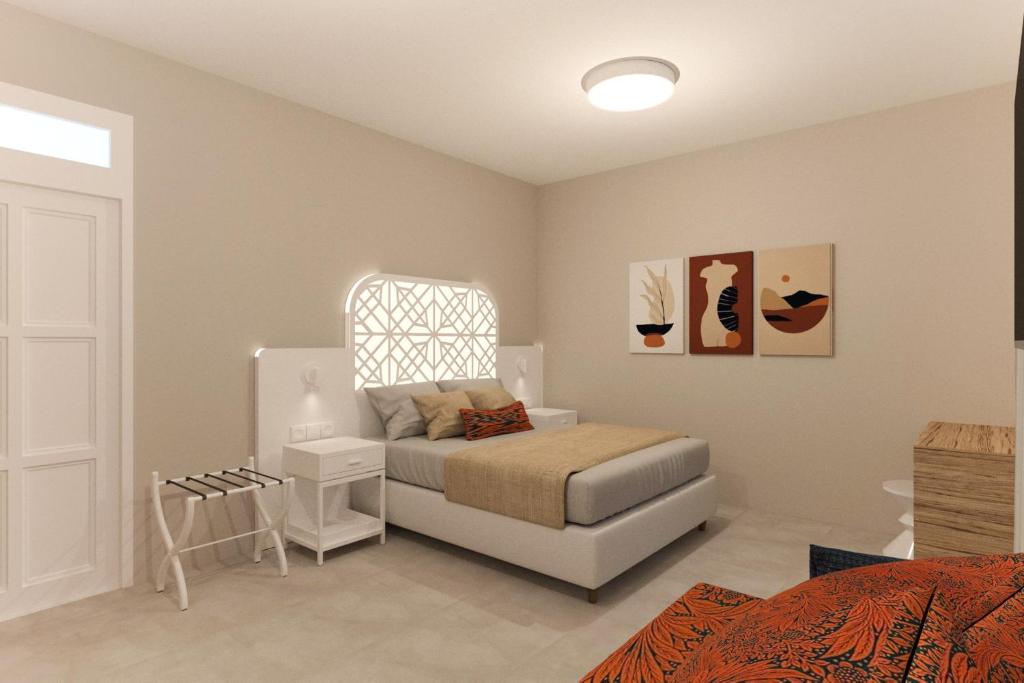 a bedroom with a bed and a nightstand and a bed sidx sidx sidx sidx at Likio Studios in Batsi