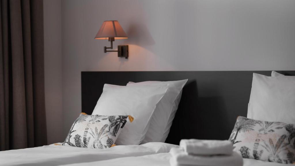 Postel nebo postele na pokoji v ubytování Le 24 Hotel