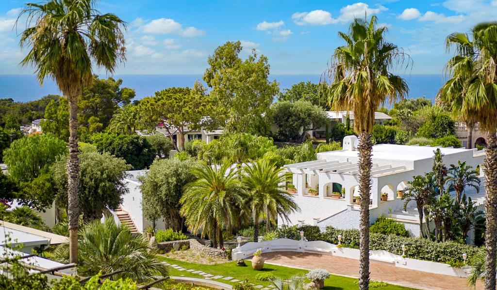 an aerial view of a white building with palm trees at Botania Relais & Spa - The Leading Hotels of the World in Ischia